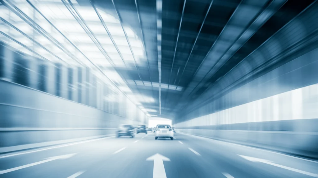 Stay ahead with NLP Strategies for WordPress image depicting a tunnel with cars driving forward.